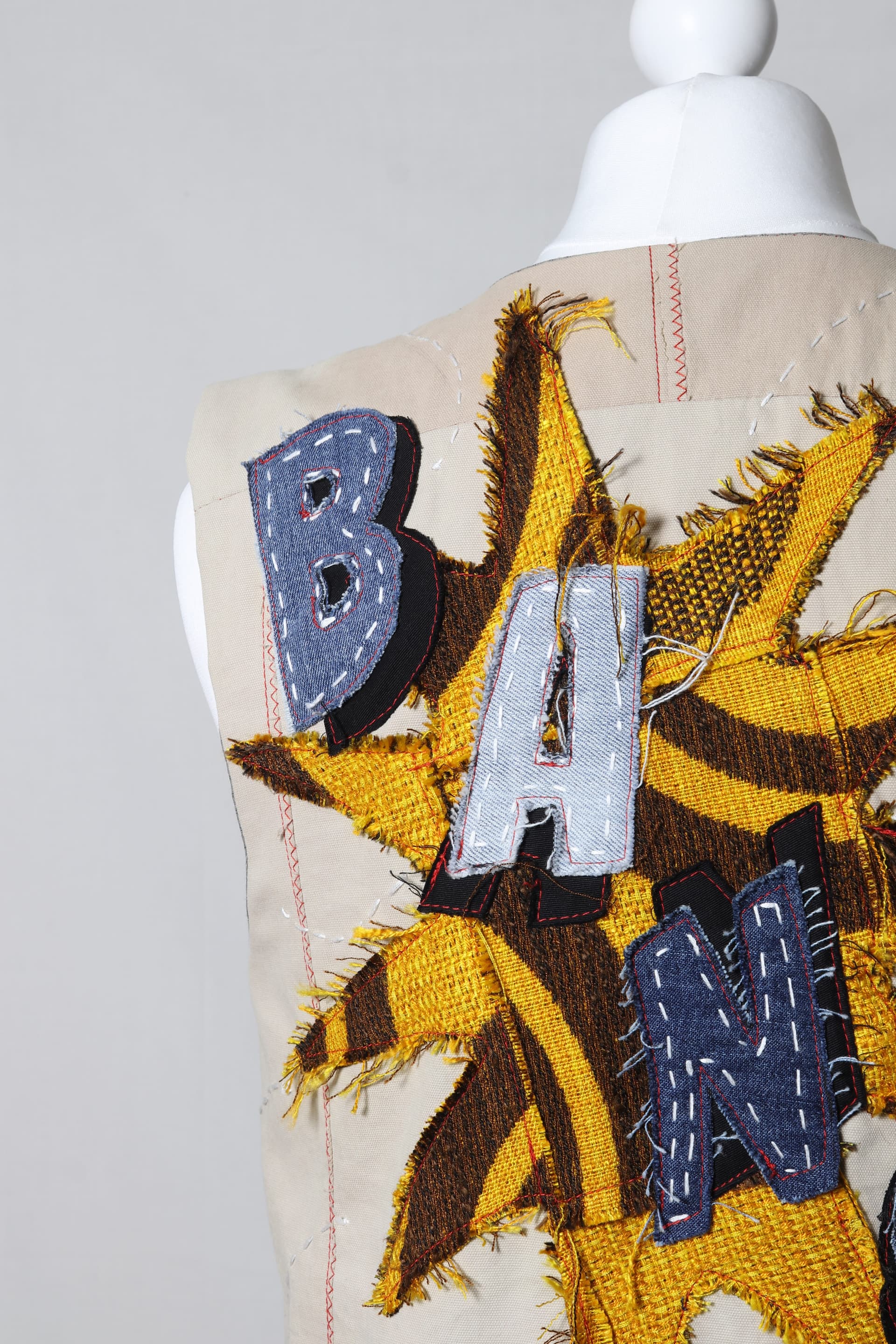 Pop art applique utility vest detail view of the cargo pocket